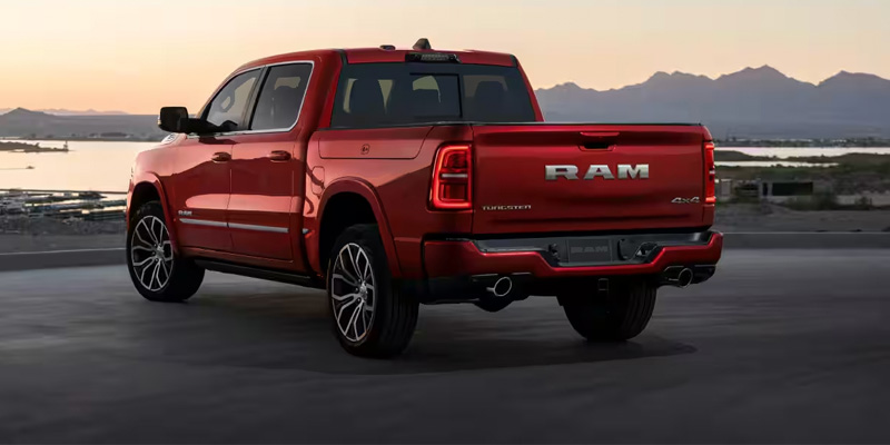 Rear view of a red 2026 RAM 1500 truck parked in Wichita Falls, TX, showcasing its distinctive tailgate and taillights.